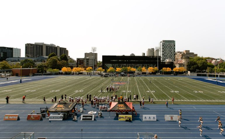 American football players on a stadium during a college campus event with event college campus