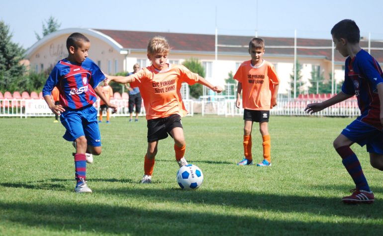 Young athlete kicking a soccer ball in a youth soccer league