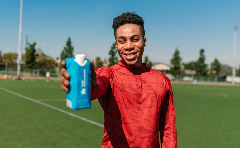 Athletes hydrating during a hot day of sports practice