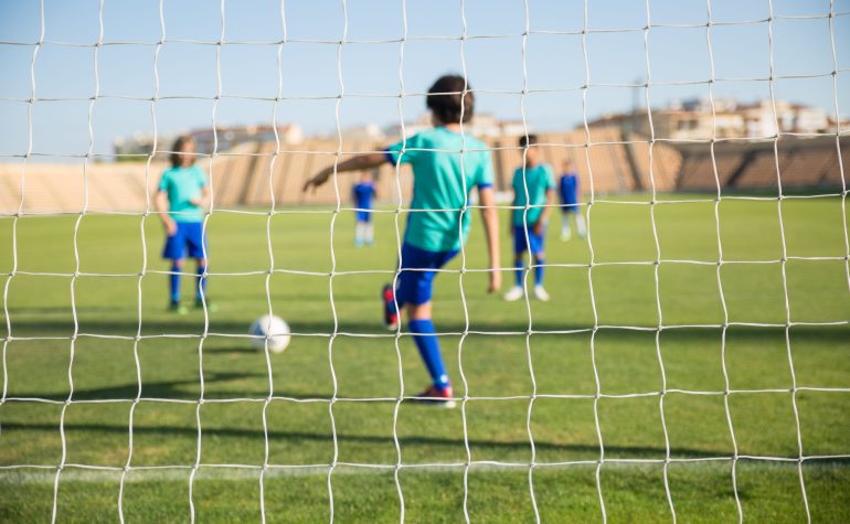 Children playing soccer in an insured youth sports league