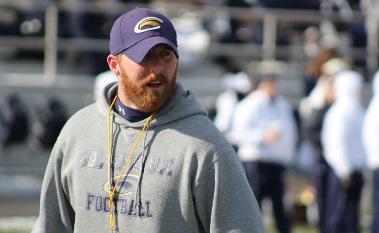 A coach leading practice, one of the fall volunteer coaches
